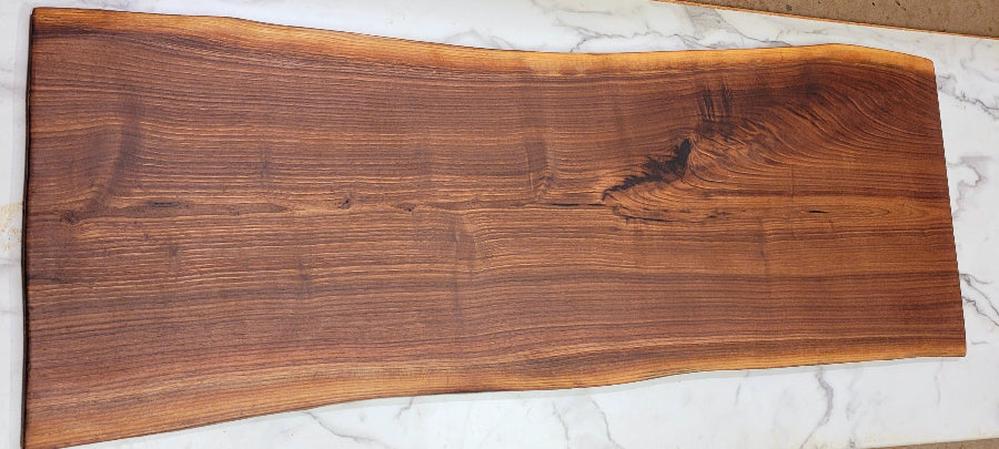 Beautiful ight coloured black walnut Grazing Board with some epoxy on surface and gorgeous wave patters on one end