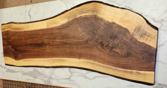 A wonderful curve art way down the grazing board with exciting natural patterns in the dark sections and light outer strip with black bark