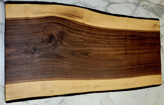 Live edge black walnut grazing board with dark centre and light border with black bark
